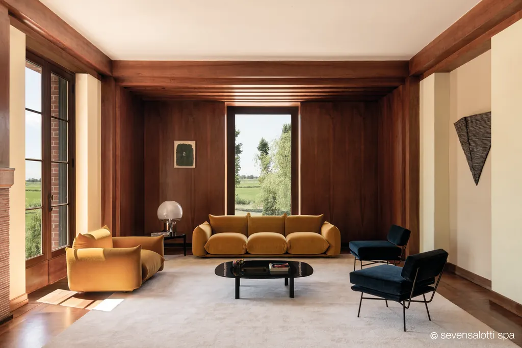 Ochre Marenco Arflex sofa and armchair in a room with wooden panelling