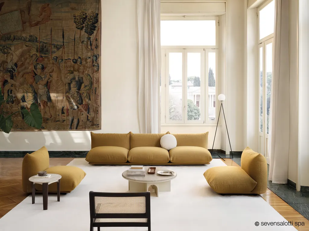 Mustard Marenco Arflex sofa and armchairs in a period living room with a tapestry