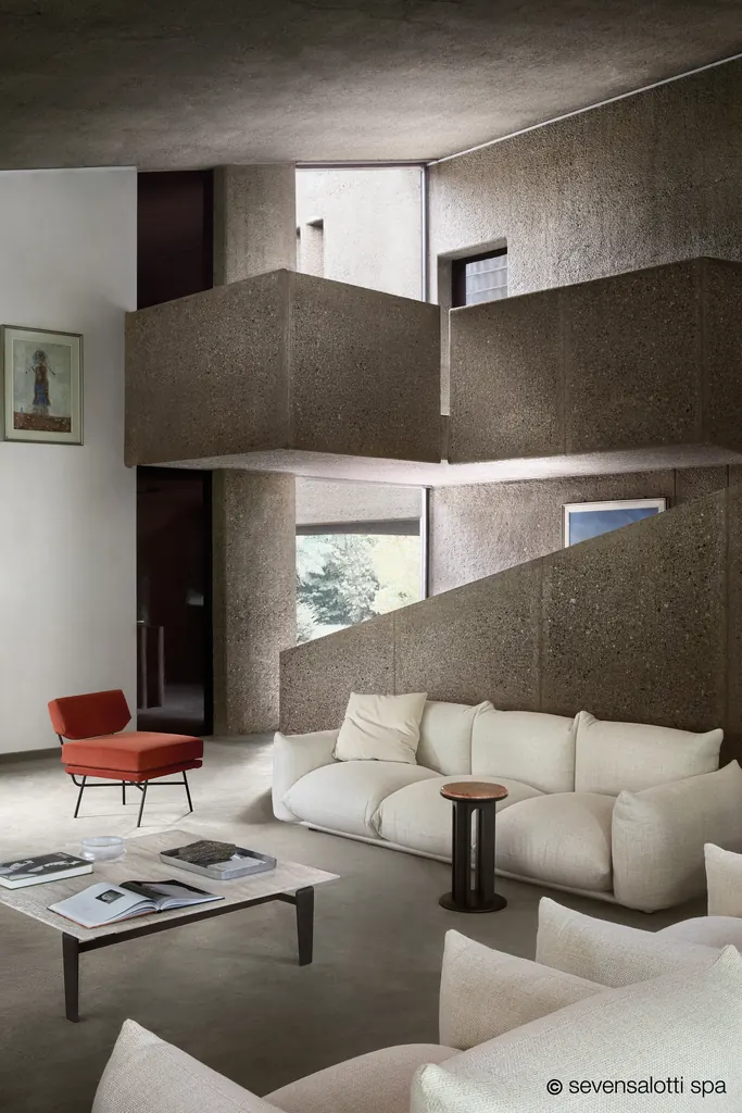White Marenco Arflex sofa in an exposed concrete interior