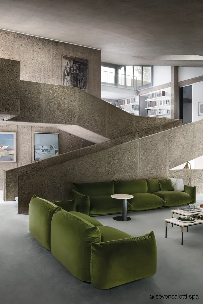 Green Marenco Arflex sofa and armchair in an exposed concrete interior